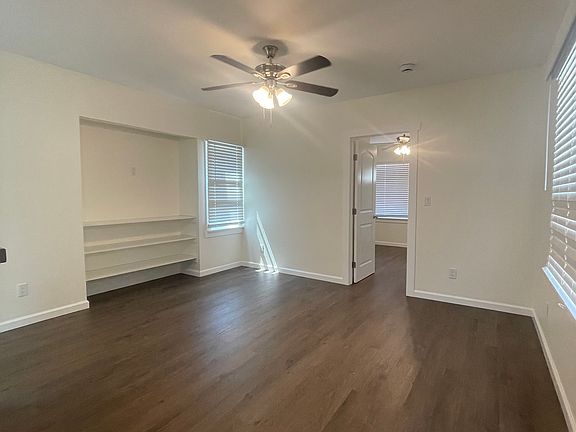 Living room with built in television space and book shelves