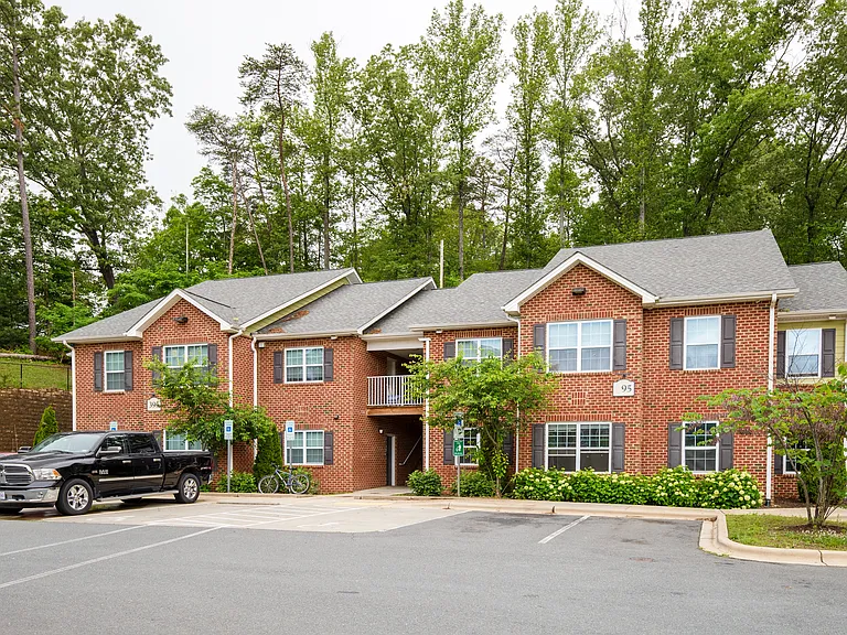 Charming red brick apartment homes surrounded by lush greenerywhere peaceful living meets thoughtful design.