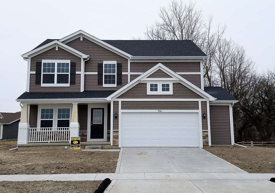 This home is situated on a large corner lot, backing up to a wooded pond