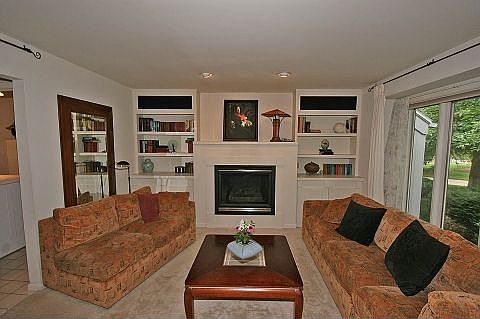 Family room with built in book cases and fire place