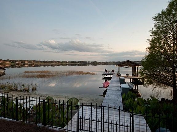 Dock and beach overlooking Lake Bessie and Isleworth golf course