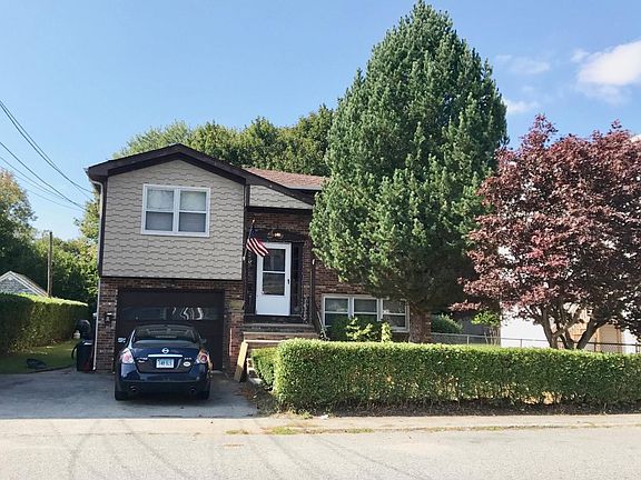 Front of house, attached garage and off street parking