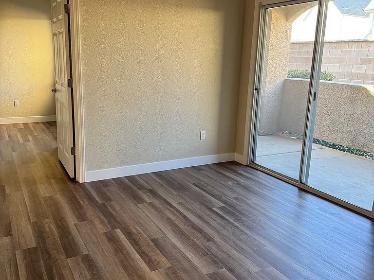 Bright living room with sliding door access to private patio