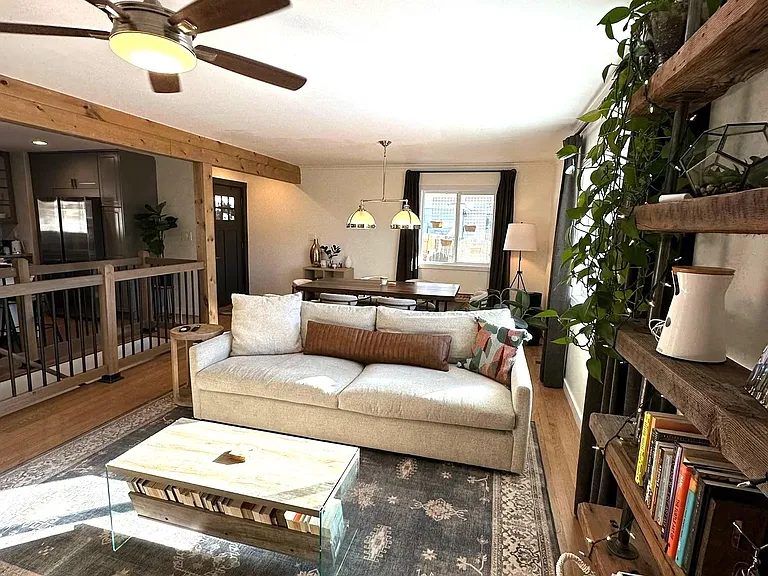 Living area adjacent to kitchen - open starway is on left (at edge of frame) with kitchen to the left of that