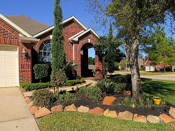 Picturesque landscaping perfectly frames the architecturally pleasing entrance.