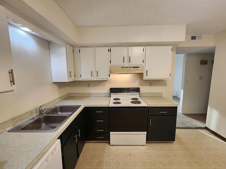 Kitchen under remodel. New flooring with white baseboards to be complete 6-30-2026