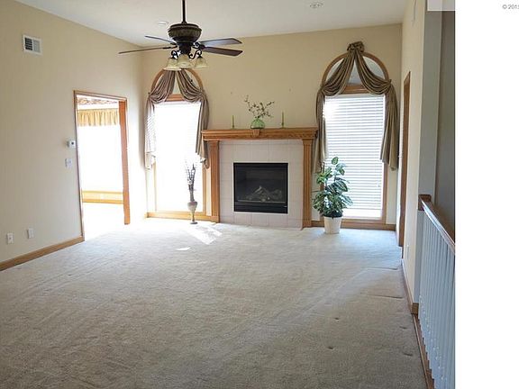Impressive Great Room as you walk in the door. Ceiling fan, fireplace and side windows.  Neutral decor. Carpet in excellent condition.