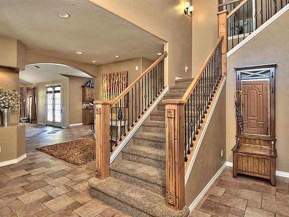 Look at the detail work! - Custom tile flooring, arched entries & a wood & wroug