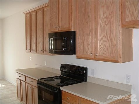 Kitchen: Black Appliances including Microwave