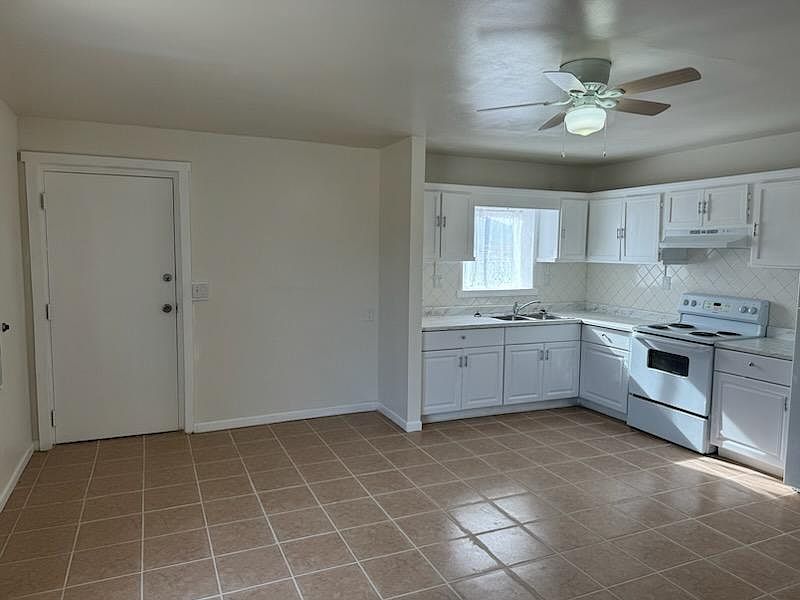 The door on the left is the main entrance and the room is the main living area.