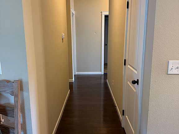 Hallway to bedrooms, bathroom, laundry room, and garage. One lined closet and hall closet