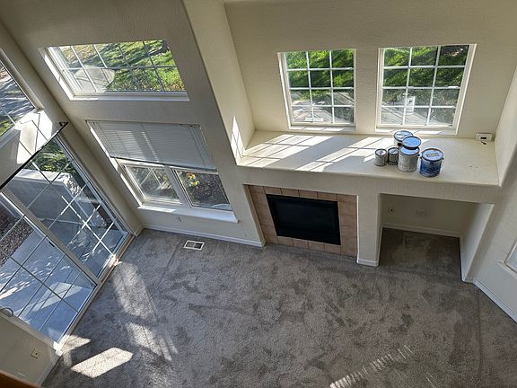View of living room from upstairs balcony. Ignore the paint cans!