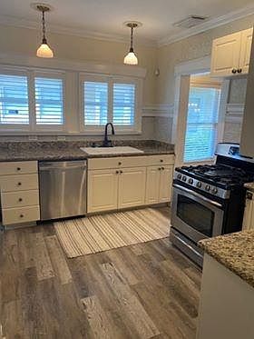 beautiful kitchen with engineered hardwood floors, granite counters and stainless steel appliances