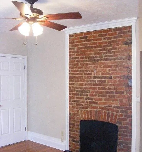 Living room with exposed brick feature