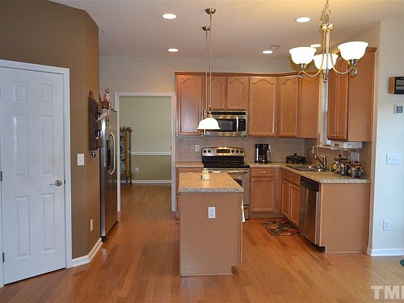 Great space for cooking and entertaining.  Island with storage, pendant lights, large walk-in pantry, SS appliances, recessed lights, access to over side patio area through glass sliders.  Extend your entertaining area to the fenced in area outdoors!