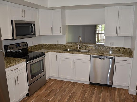 Remodeled kitchen with granite and new stainless steel appliances. Porcelain wood look tile. 