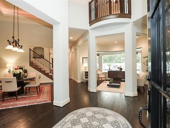 TWO STORY ENTRY - The striking entry features a Juliet balcony that overlooks the entry. To the right is a raised office all with gorgeous hand-scraped hard wood floors. Stunning entry shows off the gorgeous hard wood floors.