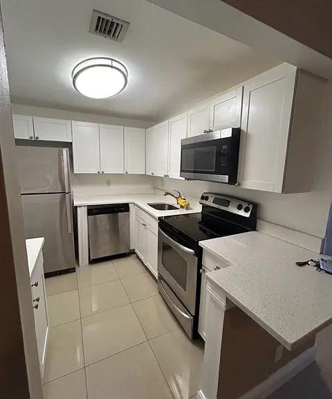 brand new white kitchen with white granite counter top