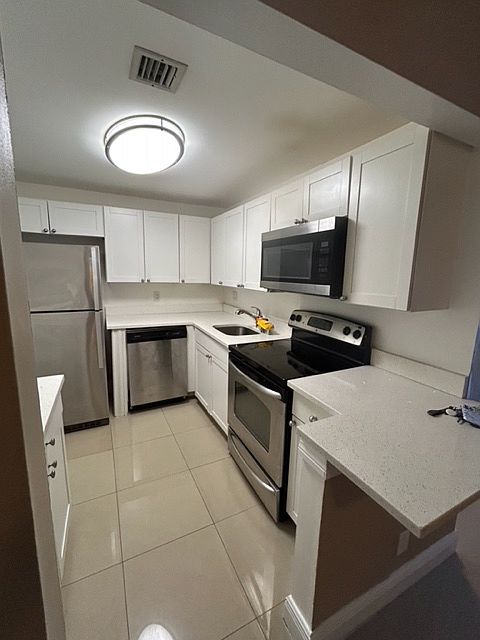 brand new white kitchen with white granite counter top