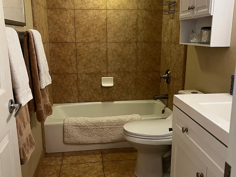 Central Bath remodeled with glass shower doors, vanity, storage and new hardware.