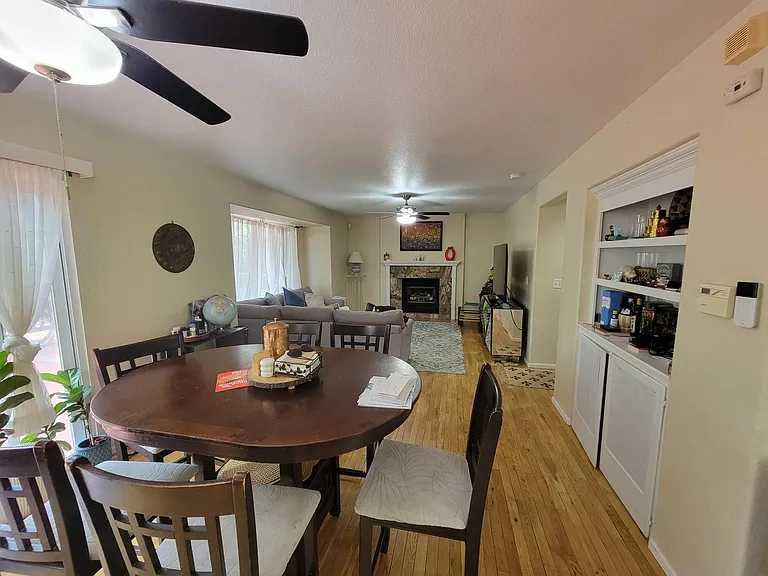 eat in area looking toward family room with fireplace and wood floors