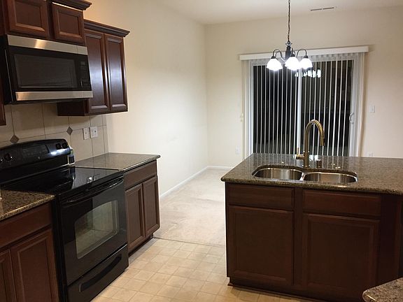 Kitchen facing dining and back yard.