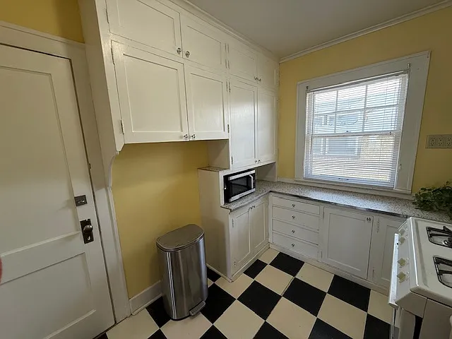 A classic 1920's kitchen! Original cabinets with new countertop. Microwave included.