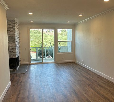 Living room / Dining room with recessed lights, crown molding and view of expansive greenbelt