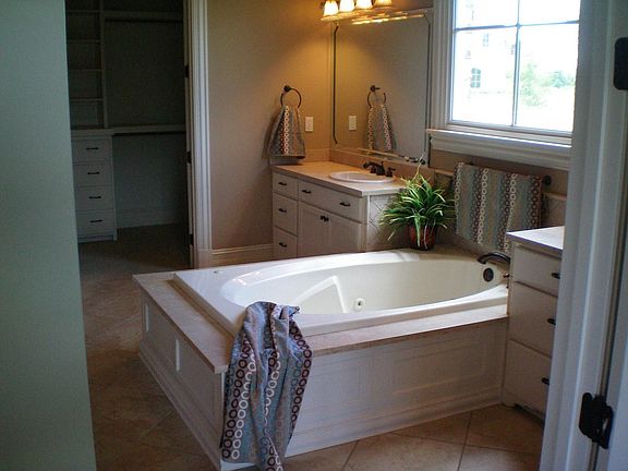 Master Bath with Marble Surfaces, Vanity, Walk in Closet with Built-Ins