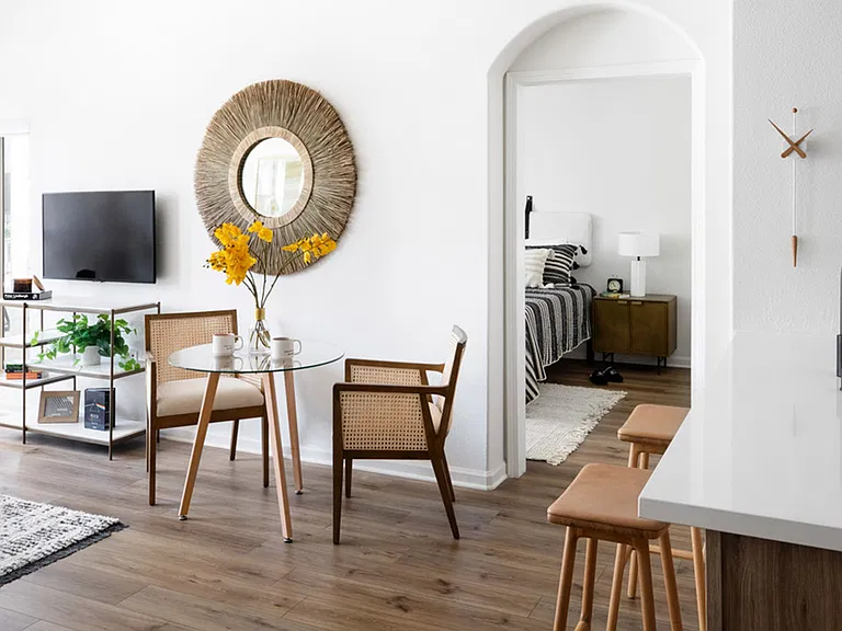 Apartment dining room with wood-style flooring.