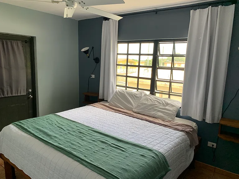 Bedroom #2 with street side balcony access. King bed.