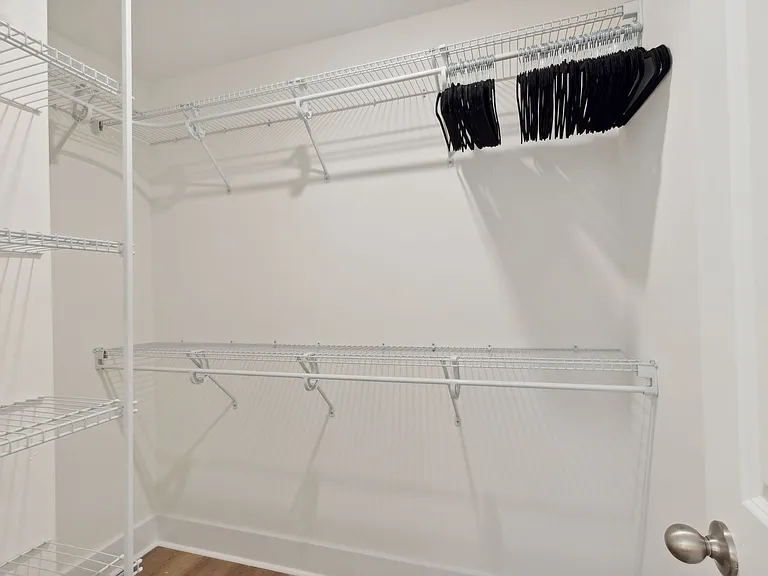 Primary bedroom walk in closet