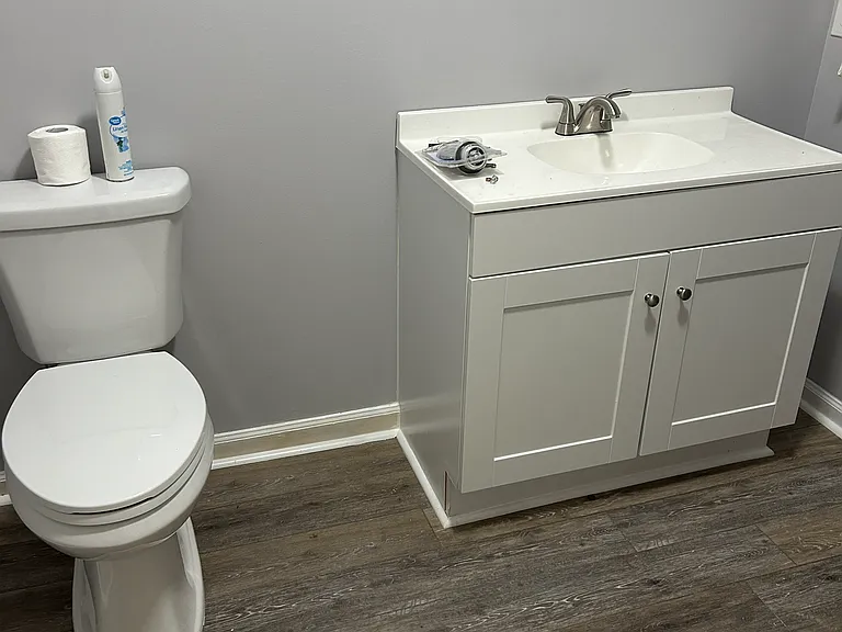 Bathroom has a tub and shower plus two storage closet areas.