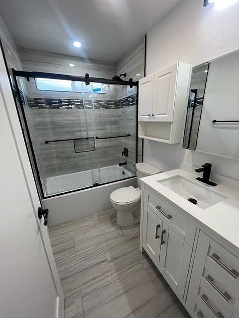 Remodeled bathroom with new shower and vanity. Contemporary Glass shower doors.
