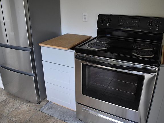 New stainless Range; Nearly complete tile floor