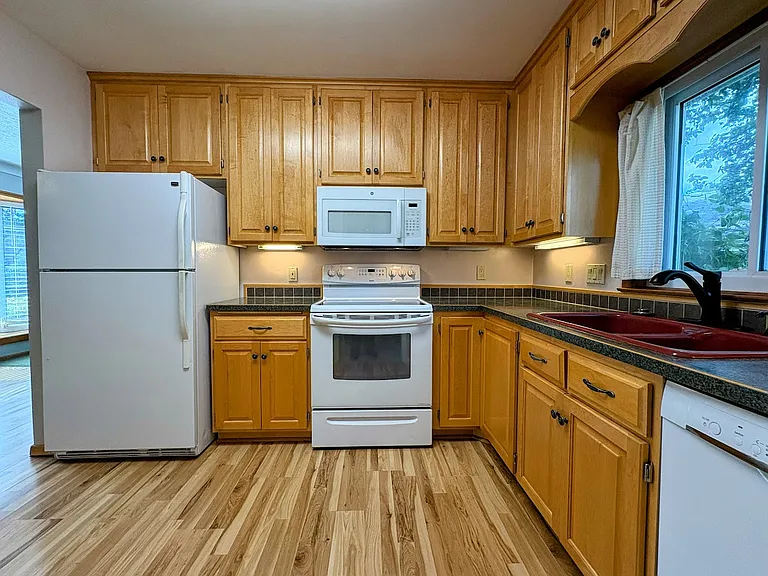 Beautifully updated kitchen, Custom Maple Cabinetry. All kitchen appliances and upgraded HE Washer/Dryer included.