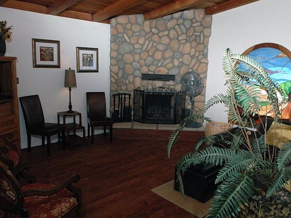 Living room with rock fireplace and stain glass window