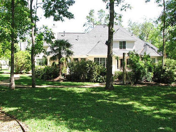 A wrought iron fence surrounds this picturesque backyard!