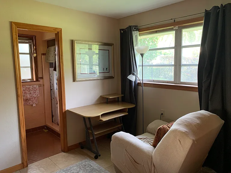 Desk in primary bedroom. Chair can be swapped out for a desk chair per tenant's preference.