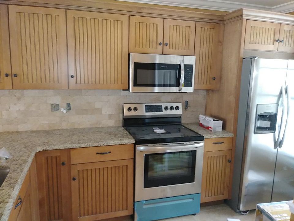 New kitchen cabinets with stainless steel appliances.