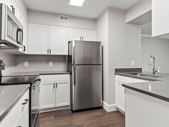Select homes have upgraded kitchens with quartz countertops and wood flooring