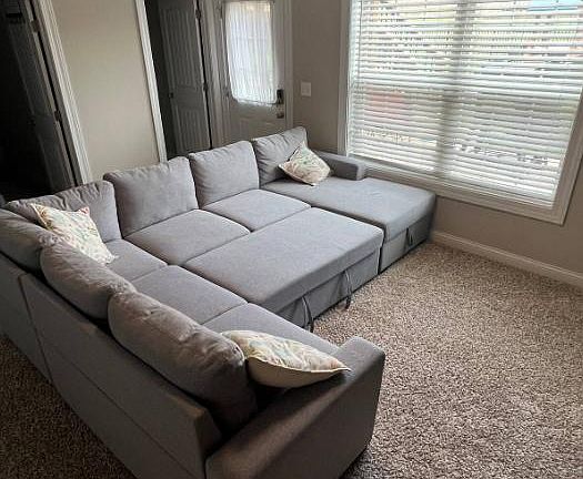 Couch extends into an additional sleeping area.