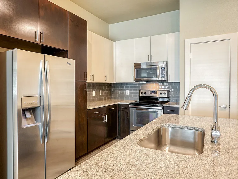 Gourmet Kitchens complete with stainless steel appliances and granite slab countertops