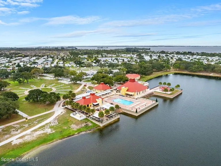 Aerial view of Barefoot Bay Recreational Community. Pool #1, Outdoor Stage, Building A, Pool room with meeting area.