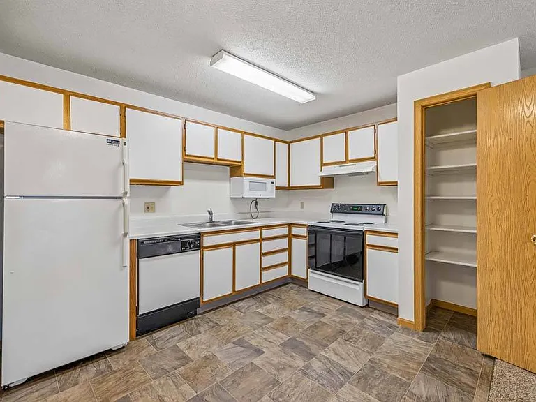 A thoughtfully designed kitchen with abundant cabinet storage and a functional layout makes preparing meals feel simple and inviting.