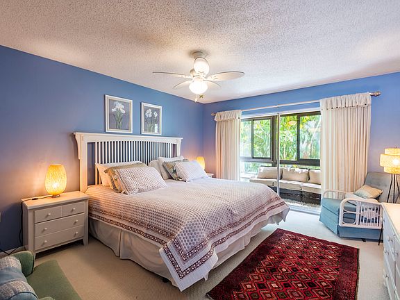 Bedroom upstairs with King size bed and lanai overlooking the garden.