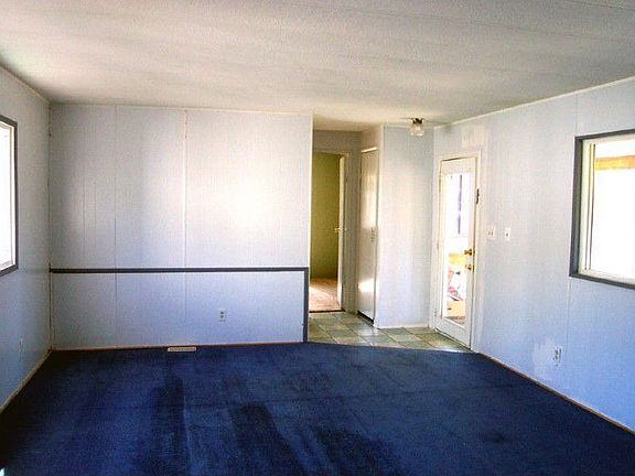 Living room looking East toward hall bathroom & extra bedroom.