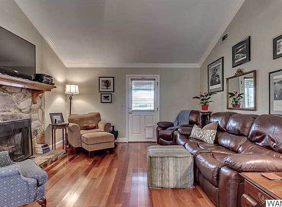 Living room has hardwood and fireplace with gas logs