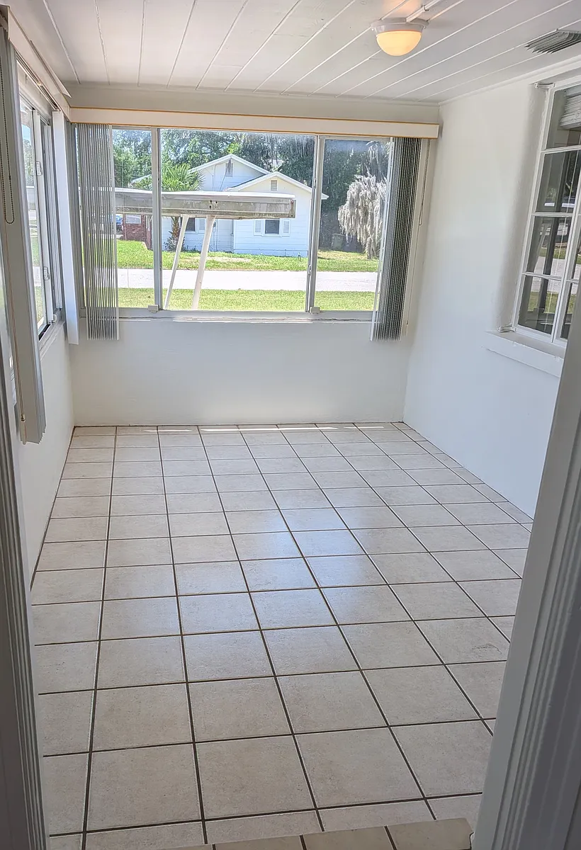 When you enter the front door you enter a sunroom. This bright and flexible space could be perfect for a home office, studio, gym, or dining area. - 209 2nd St SE #209
