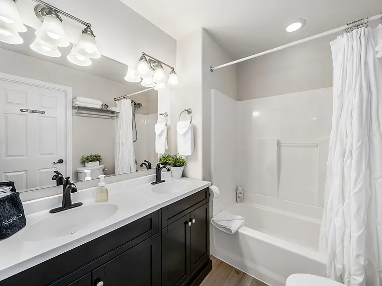 Second full-sized bath, with hallway entrance and direct bedroom access.